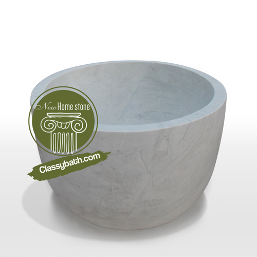 Deep soaker tub in white marble